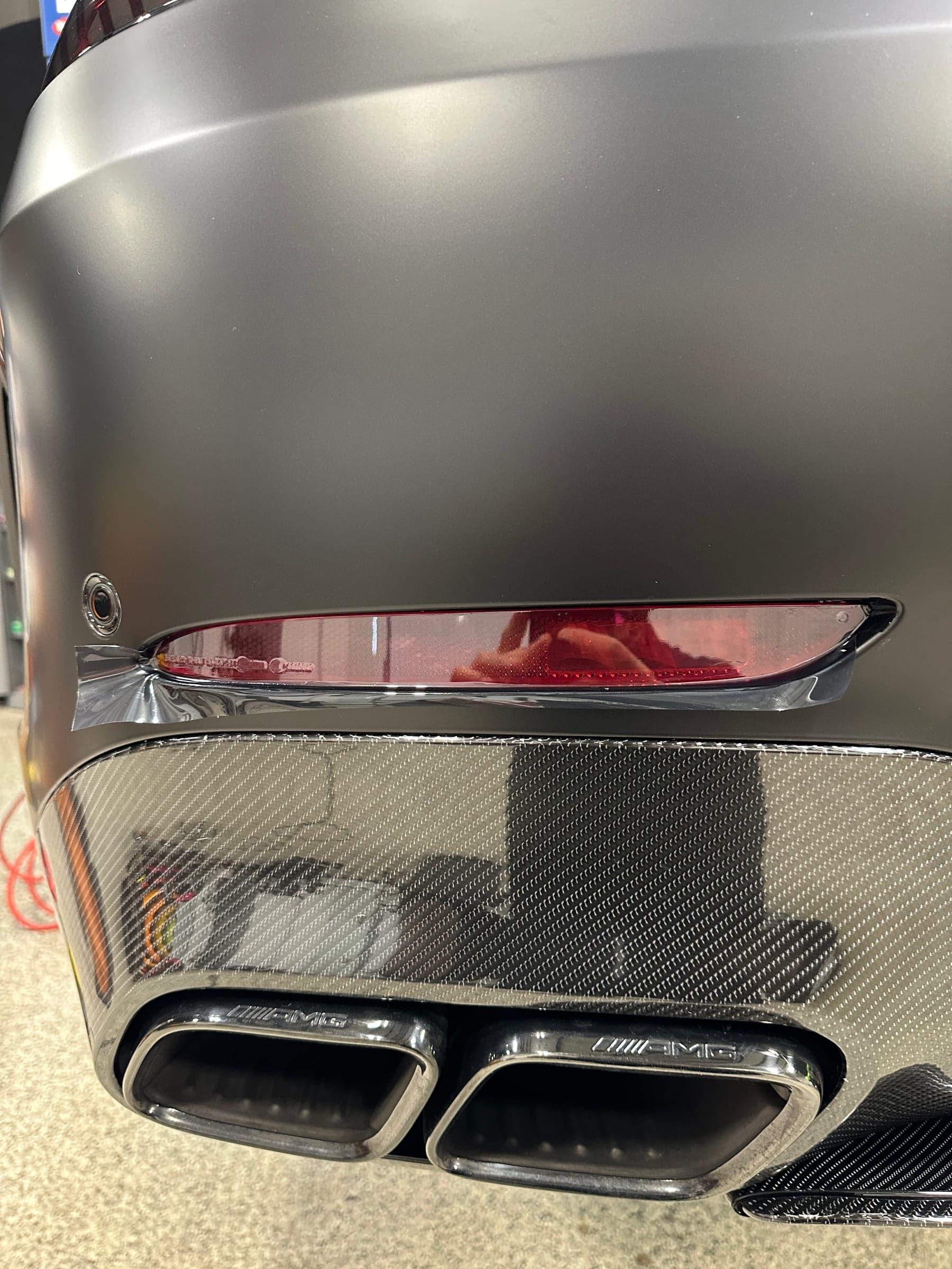 Bumper marker lamp wrapped in ONE PPF Dark Smoke film